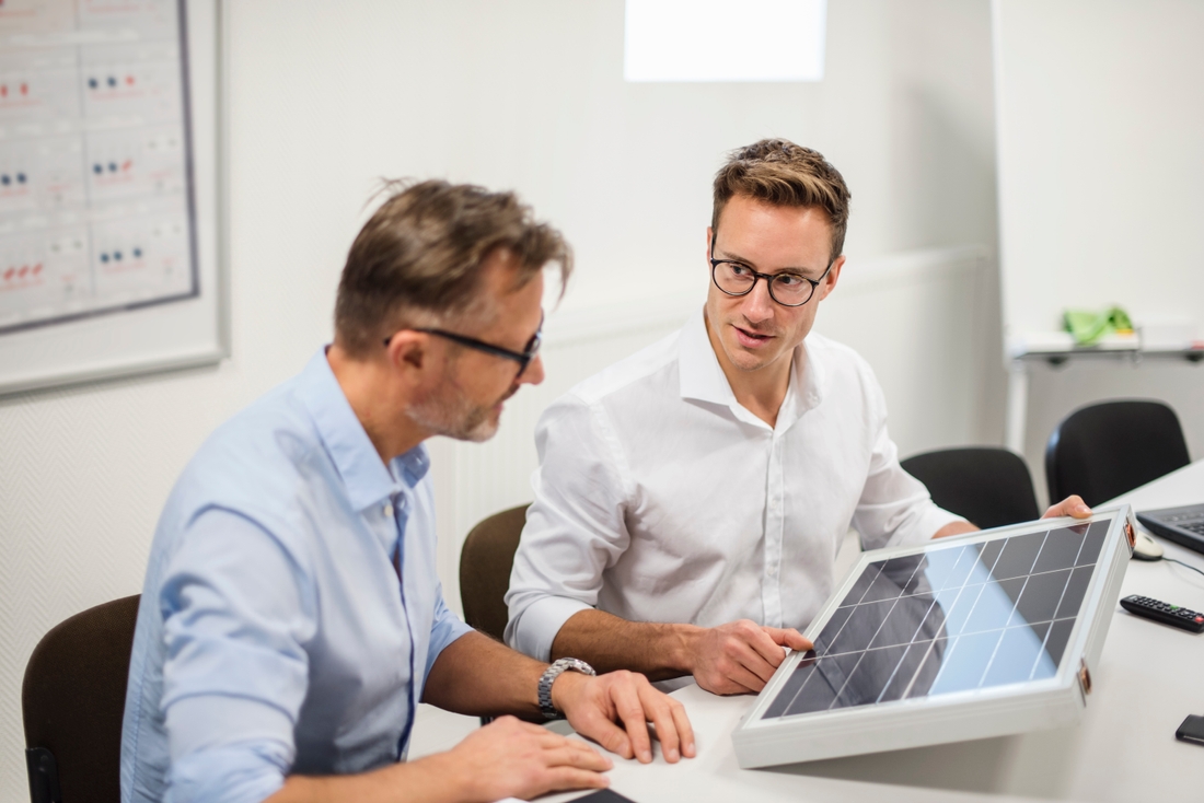 Two men are sitting in a meeting